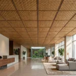 Luxury hotel lobby featuring eco-friendly woven bamboo ceiling panels in a modern grid system.