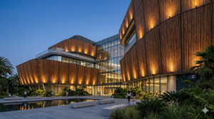 A modern eco-friendly commercial building featuring a sustainable bamboo wall facade with architectural lighting at dusk.